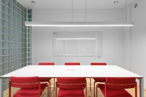 A conference room with red chairs